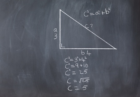 Right triangle with pythagorean formula and calculations on a blackboardの写真素材