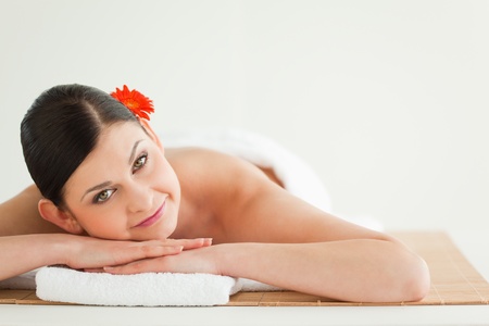 Attractive dark-haired woman getting a spa treatment lying downの写真素材
