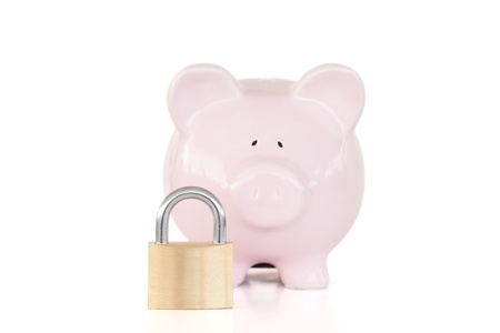 Pink piggy bank and padlock against a white background. の写真素材