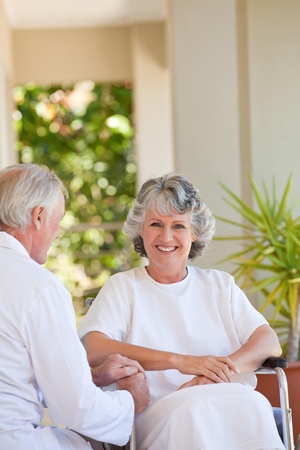 Doctor with his patient in her wheelchairの写真素材