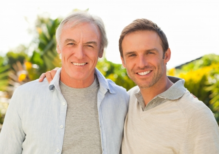 Father and his son looking at the camera in the garden