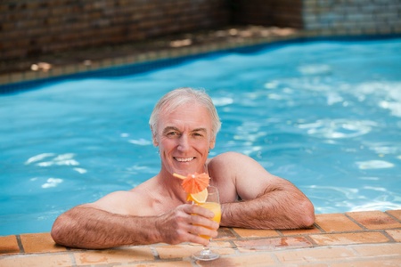 Senior man in his swimming poolの写真素材