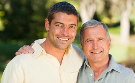 Father with his son looking at the camera in the park