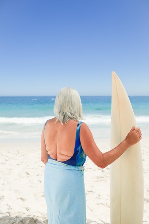 Mature woman with her surfboardの写真素材