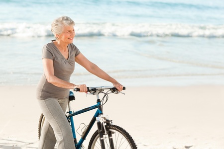 Senior woman with her bikeの写真素材