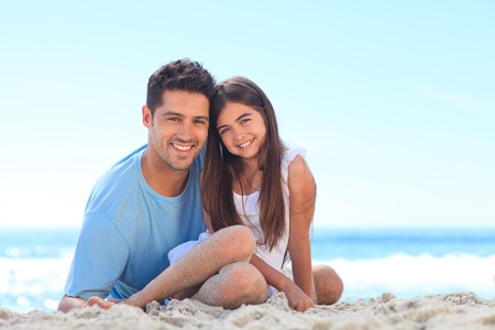 Father with his daughter at the beachの写真素材