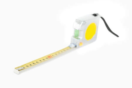Yellow measuring tape against a white backgroungの写真素材