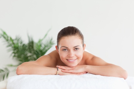 Brunette lying on a massage table in a spaの写真素材