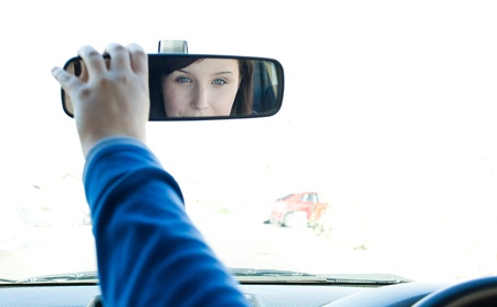 Caucasian woman looking in the rear-view mirrorの写真素材