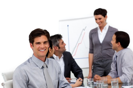 Smiling male executive at a presentation with his team の写真素材
