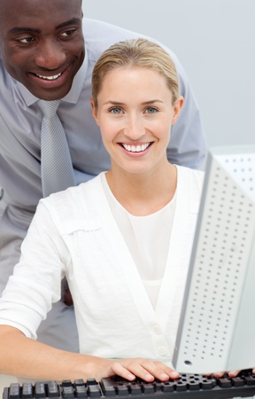 Afro-american businessman and his colleague working at a computerの写真素材