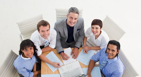 High angle of a positive business team studying a document の写真素材