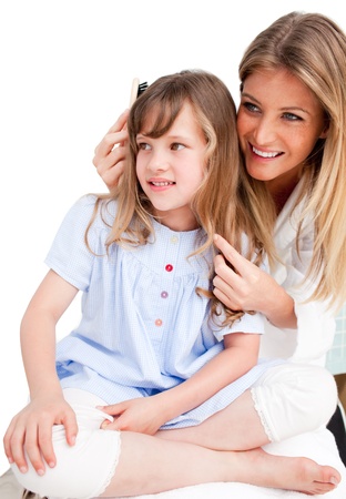 Mother Looking At Her Daughter's Hairの写真素材