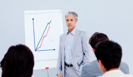 Senior manager giving a presentation to his colleagueの写真素材