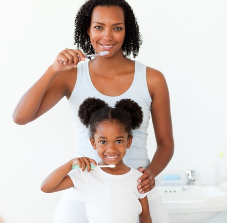 Mother and her daughter brushing their teethの写真素材