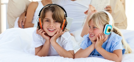Close-up of brother and sister listening musicの写真素材