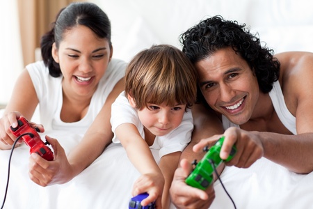 Portrait of smiling parents playing video games with their son