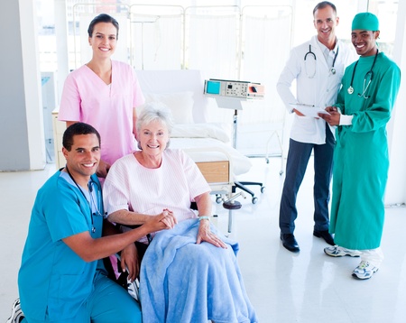 Attentive medical team taking care of a senior womanの写真素材