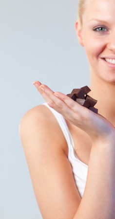 Beautiful woman holding chocolate focus on chocolate の写真素材