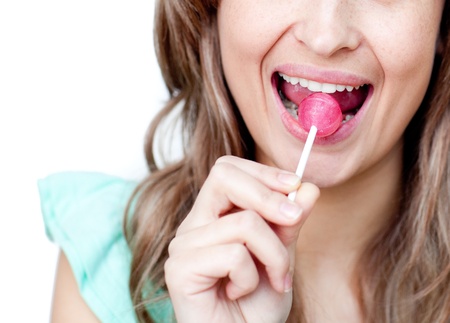 Close-up of a woman eating a lollipop 