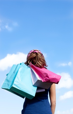 Smiling woman holding shopping bags outdoor の写真素材