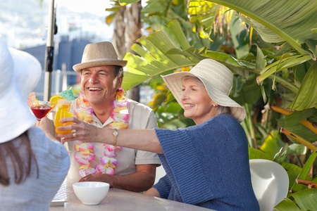Retired woman drinking a cocktail under the sunの写真素材