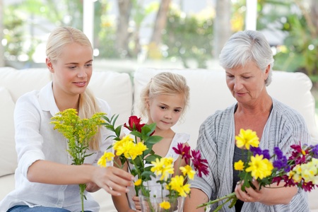 Radiant family with flowers at homeの写真素材