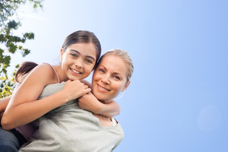 Mother and her daughter laughting in the parkの写真素材