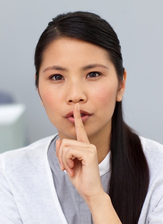 Charming businesswoman asking for silenceの写真素材