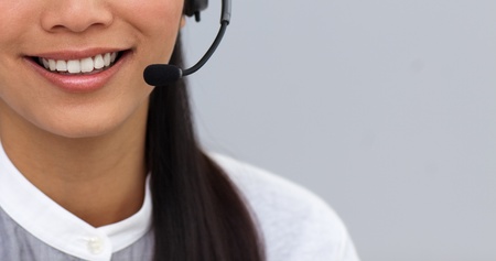 Close-up of a businesswoman using headsetの写真素材