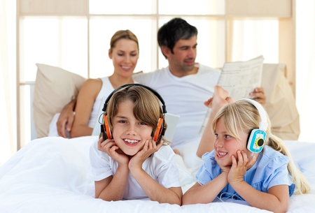 Brother and sister listening music with headphones Brother and sister listening music with headphones