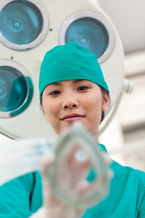 Young doctor applying oxygen mask to a patient の写真素材