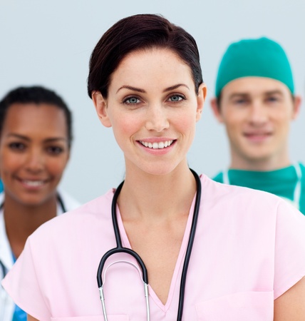 Female Doctor standing in Front of her teamの写真素材