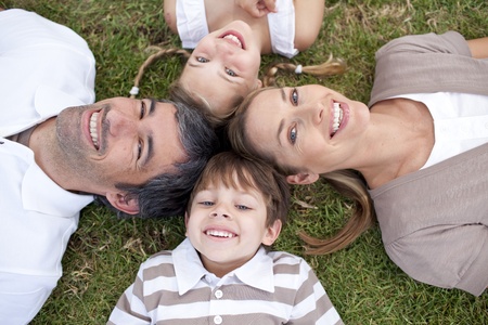 Tired family lying in a parkの写真素材