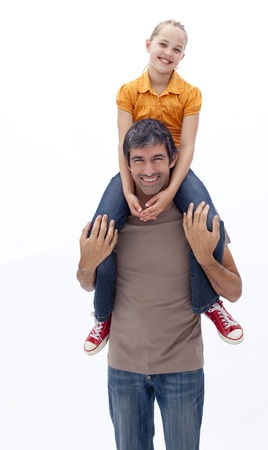 Father giving daughter piggyback rideの写真素材