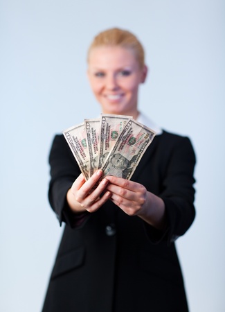 Business woman holding up dollars の写真素材