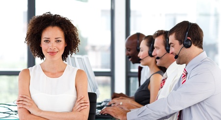 Attractive businesswoman with folded arms in a call centerの写真素材