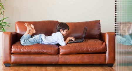 Young kid playing with a laptopの写真素材