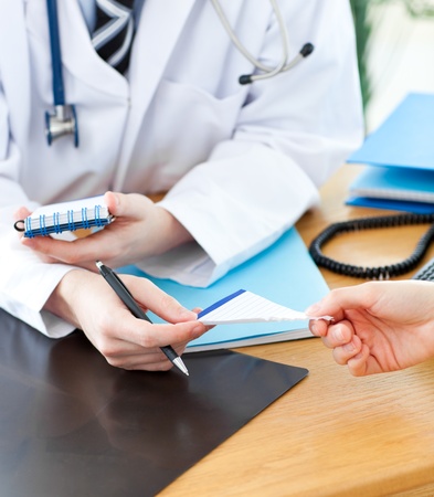 A doctor giving his patient a prescriptionの写真素材