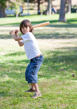 Cute little boy playing baseballの写真素材