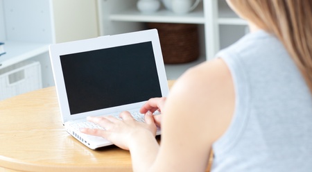 Sweet woman sitting in front of her laptopの写真素材