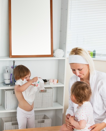 Mother taking care of her childrenの写真素材
