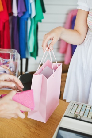 Caucasian saleswoman giving a shopping bag to a customer の写真素材