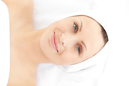 Portrait of a cute young woman lying on a massage smiling at the camera の写真素材