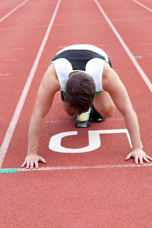 Athletic man waiting in starting blockの写真素材