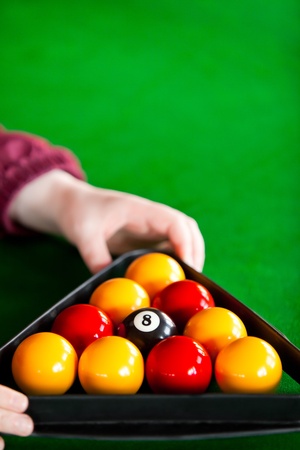 Close-up of a snooker player placing balls with triangleの写真素材