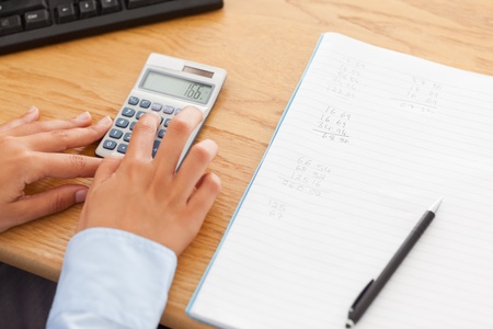 Woman calculating in her office