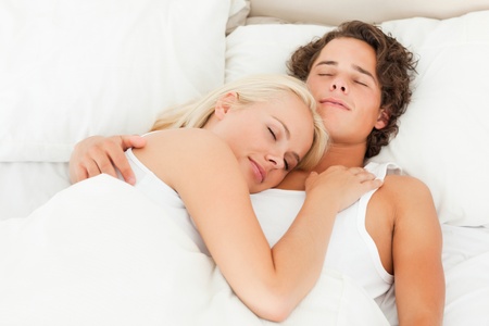 Lovely couple sleeping in their bedroomの写真素材