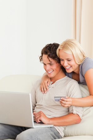 Portrait of a couple shopping online in their living roomの写真素材