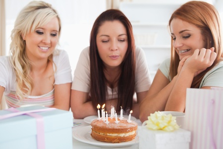 Gorgeous Women celebrating a birthday in a kitchenの写真素材